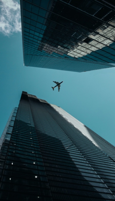 airplane flying over buildings