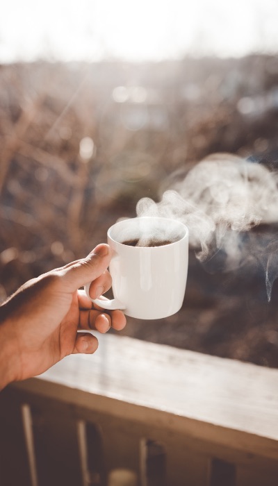 hand holding mug of coffee